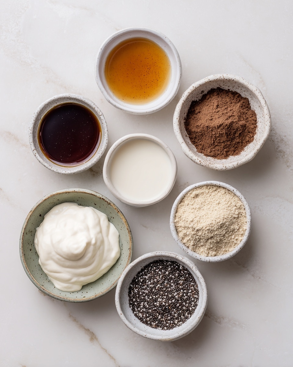 The image shows seven small white bowls arranged on a white marbled surface, each containing a different ingredient. Starting from the top left and moving clockwise, there is a bowl with dark brown liquid labeled maple syrup, next to it a pale brown liquid labeled vanilla extract in a slightly smaller bowl. Beside it is a bowl with white milk. Below is a bowl with very fine dark brown instant coffee powder. Further down is a bowl filled with beige protein powder. To the left of that is a bowl with smooth white Greek yogurt, and lastly in the center is a bowl holding black chia seeds with a textured surface. All bowls are clean and neatly filled. Photo taken with an iphone --ar 4:5 --v 7