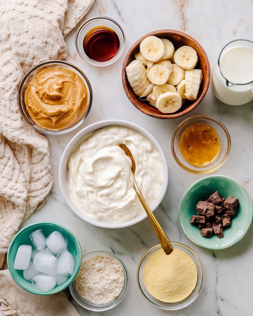 The image shows several small bowls and containers arranged on a white marbled surface. There is a white bowl with a creamy, thick white mixture and a gold spoon inside near the center. Above it, there is a wooden bowl filled with whipped cream. To the left, a small glass bowl holds a light brown smooth peanut butter, and next to it, a larger white bowl contains frozen banana slices. A small glass bowl with dark brown liquid and another white bowl with a golden honey-like liquid are also visible. At the bottom left is a glass container filled with ice cubes. Near the center right, there is a turquoise bowl with pale yellow powder, and a white bowl with small dark brown crispy pieces beside it. A glass pitcher with white milk is at the top right. A white and beige cloth is partially seen on the left. Photo taken with an iphone --ar 4:5 --v 7
