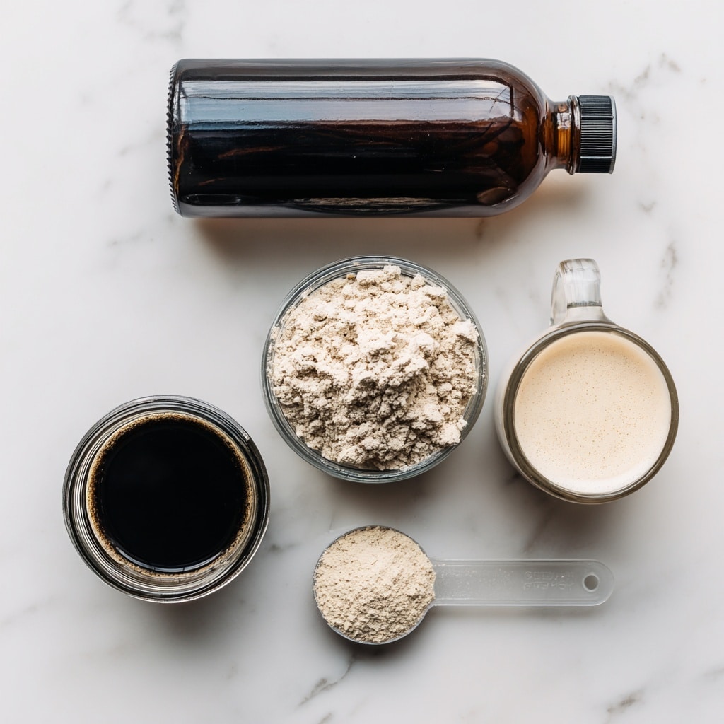 The image shows four ingredients neatly arranged on a white marbled surface. At the top is a dark brown bottle of vanilla extract with a white label and black cap, lying horizontally. Below it, on the left, is a round glass jar filled with dark, almost black coffee or espresso. To the right of this jar is a small glass bottle with frothy milk inside. At the bottom of the image, a transparent plastic measuring spoon holds a light beige protein powder, labeled as optional. Each item has clear black and white text labels next to them. photo taken with an iphone --ar 4:5 --v 7