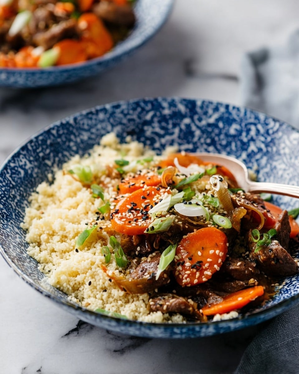 A blue and white patterned bowl holds a dish with two main layers. The bottom layer is light, fluffy couscous in small grain form, pale cream in color. On top is a mix of sliced brown meat pieces and bright orange carrot slices, with thin translucent onion strips scattered throughout. The meat and vegetables are garnished with black and white sesame seeds and small green onion pieces. A silver fork rests inside the bowl on the right side. The bowl is placed on a white marbled surface with another similar bowl blurred in the background. photo taken with an iphone --ar 4:5 --v 7
