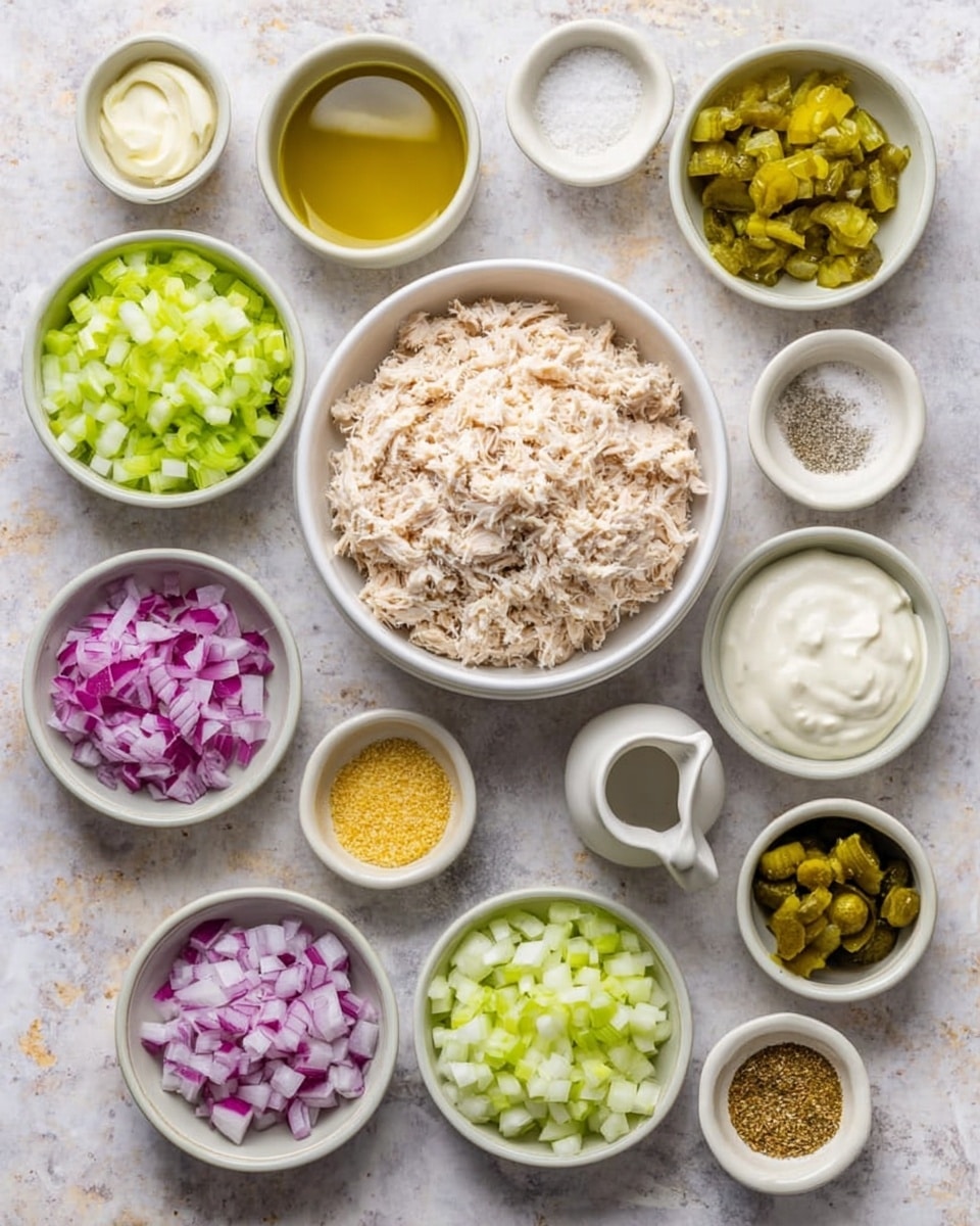 A croissant sandwich on a white plate with a light beige rim sits on a white marbled surface. The sandwich has a golden brown, flaky croissant cut in half horizontally. Inside, there is a green leaf of lettuce at the bottom, topped with a thick layer of creamy chicken salad mixed with small pieces of celery and onion. Two pickle slices lie on the plate beside the sandwich. In the blurred background, there is a second croissant sandwich on another white plate with a beige rim, and a small bowl of pickles next to a glass with water. A folded dark blue cloth is visible on the right side of the image. Photo taken with an iphone --ar 4:5 --v 7