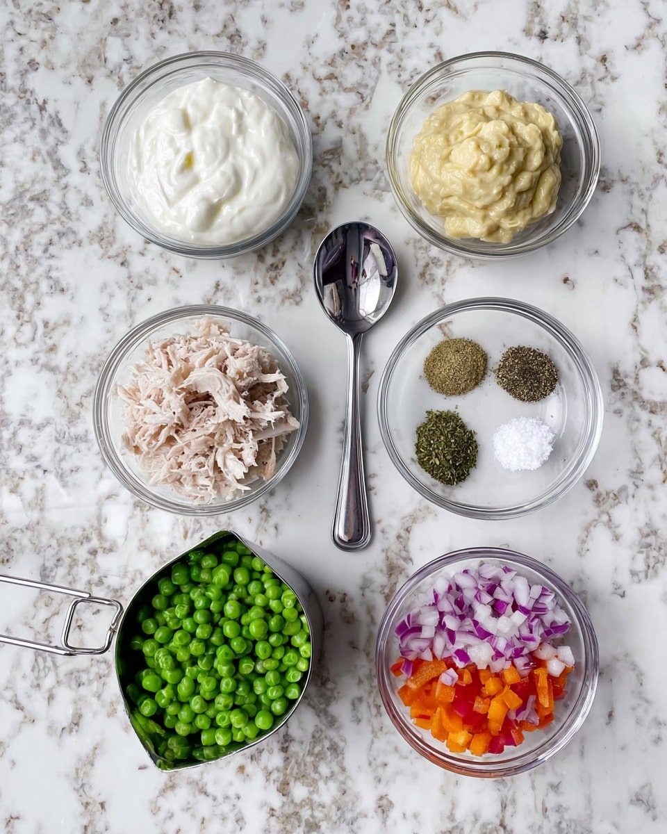 The image shows six clear glass bowls and one metal measuring cup arranged neatly on a white marbled surface. Starting from the top left, the first bowl contains a thick white creamy substance with a smooth texture. To its right is a metal teaspoon filled with a light yellow creamy paste. Next to it is a small clear glass bowl with four types of dry ingredients in separate piles: black pepper, dried green herbs, crushed garlic powder, and white salt. Below the creamy substance bowl is another filled with shredded light beige meat. In the center at the bottom is a metal measuring cup full of bright green peas. Finally, the bottom right bowl holds finely chopped vegetables with red onion pieces and diced orange-red bell pepper. photo taken with an iphone --ar 4:5 --v 7