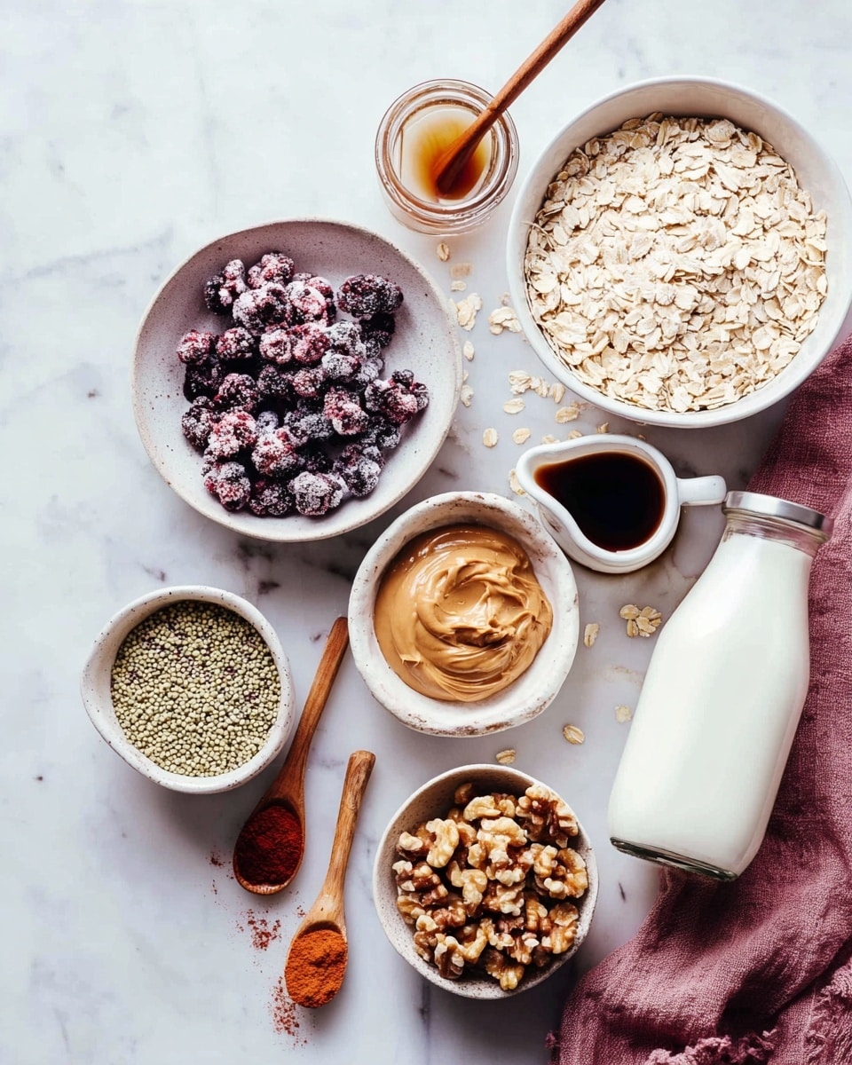 The image shows a clear glass jar filled with three visible layers: at the bottom, a pinkish berry sauce, in the middle, creamy oatmeal mixed with oats and some nuts, and on top, fresh dark blue blueberries scattered with small pieces of nuts. A thin golden spoon is placed inside the jar. The jar is set on a white marbled surface with some scattered oats and blueberries around it, with another similar jar partly visible in the background. photo taken with an iphone --ar 4:5 --v 7