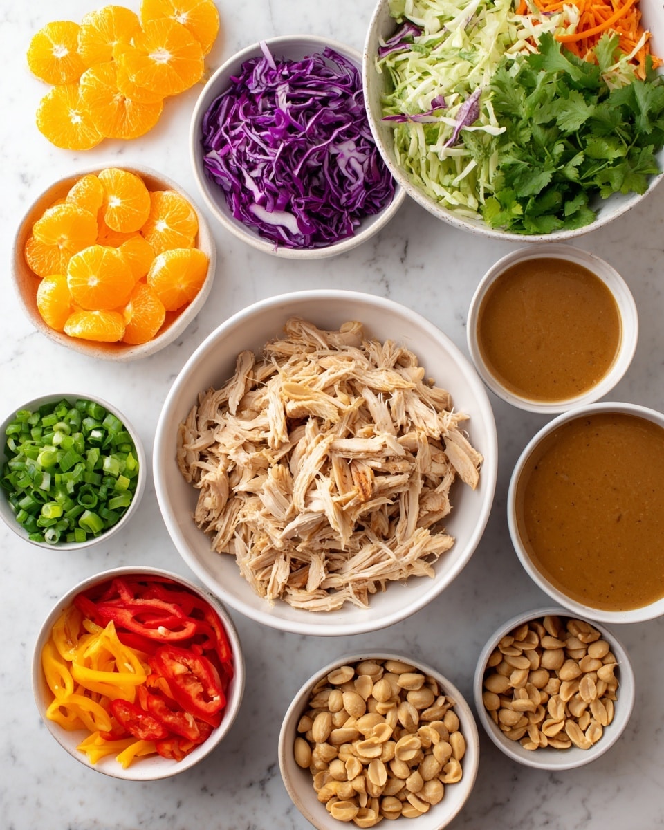 The image shows several small white bowls arranged on a white marbled surface, each filled with different fresh ingredients. In the center is a large white bowl filled with light tan shredded chicken. To the top left of it is a large white bowl holding a mix of thinly sliced green and purple cabbage. Around these bowls are smaller white bowls with bright orange mandarin orange segments, shredded orange carrots, small chopped red bell peppers, chopped green onions, green cilantro leaves, light tan sliced almonds, golden brown peanuts, and a medium-sized bowl of smooth, rich brown peanut dressing. All the items are brightly colored and neatly arranged, showing fresh textures and vibrant contrasts. Photo taken with an iphone --ar 4:5 --v 7