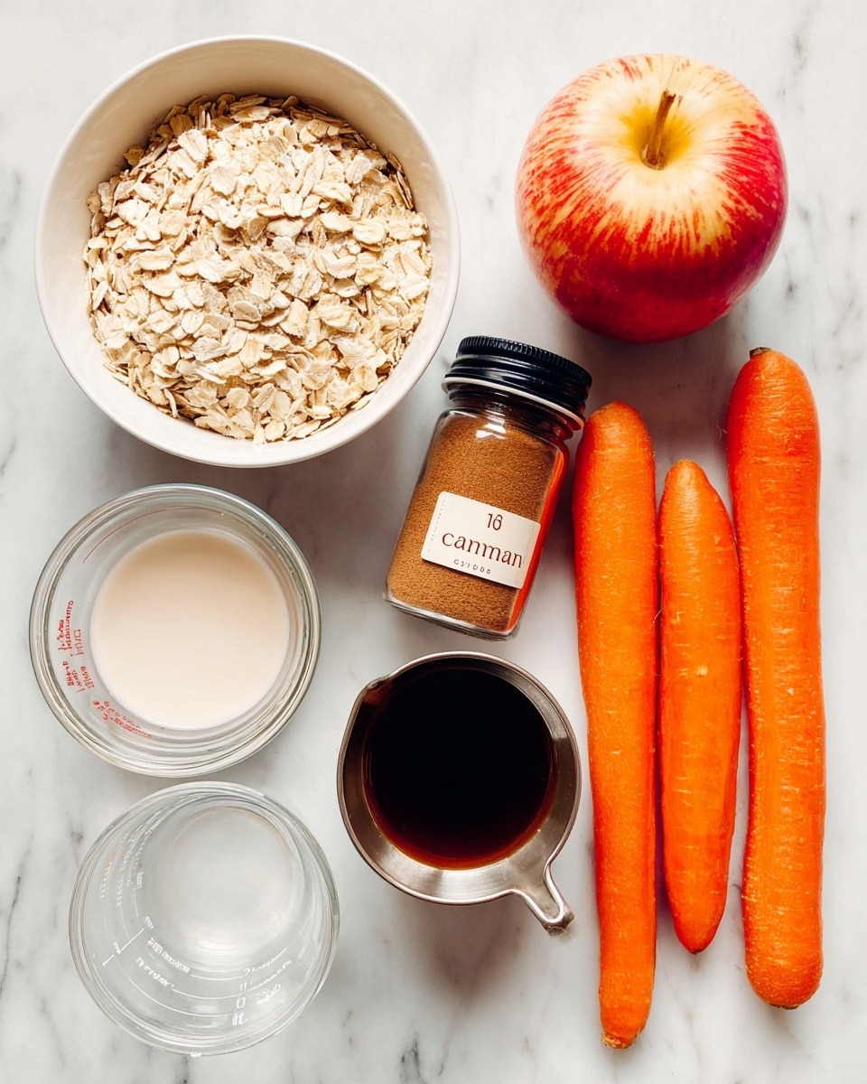 The image shows a white bowl filled with light tan rolled oats on the left side, next to a fresh red apple with yellow spots. To the right of the apple, there are three long, bright orange carrots placed close together. Above the apple and carrots, there is a small glass jar with a silver lid labeled