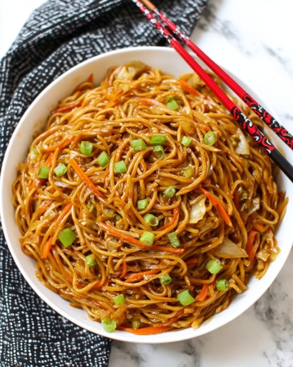 The image shows a close-up of a white plate filled with cooked noodles. The noodles are golden brown, with a shiny texture, mixed with small green onion pieces and thin orange strips of carrot. White sesame seeds are sprinkled all over the noodles. Two black and red chopsticks are picking up some noodles from the plate. The background is a white marble surface. Photo taken with an iphone --ar 4:5 --v 7