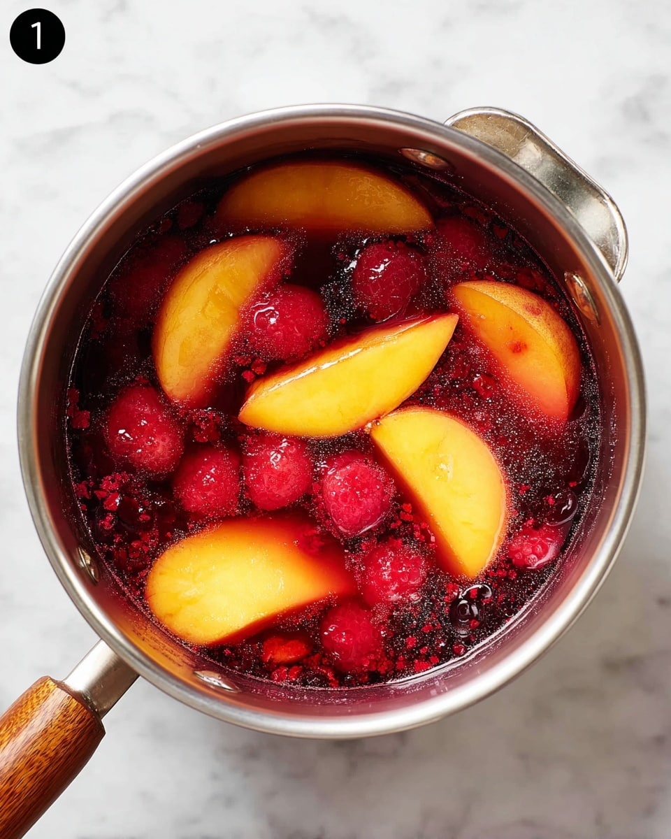 A shiny silver pot with a wooden handle is filled with a colorful mix of fruit pieces in juice. Inside, there are bright yellow-orange peach slices with smooth textures, dark red raspberries that look soft and small, and bits of crushed red berries spreading through the liquid. The fruit pieces float in a deep red, clear juice that shines under the light. The pot sits on a white marbled surface. photo taken with an iphone --ar 4:5 --v 7