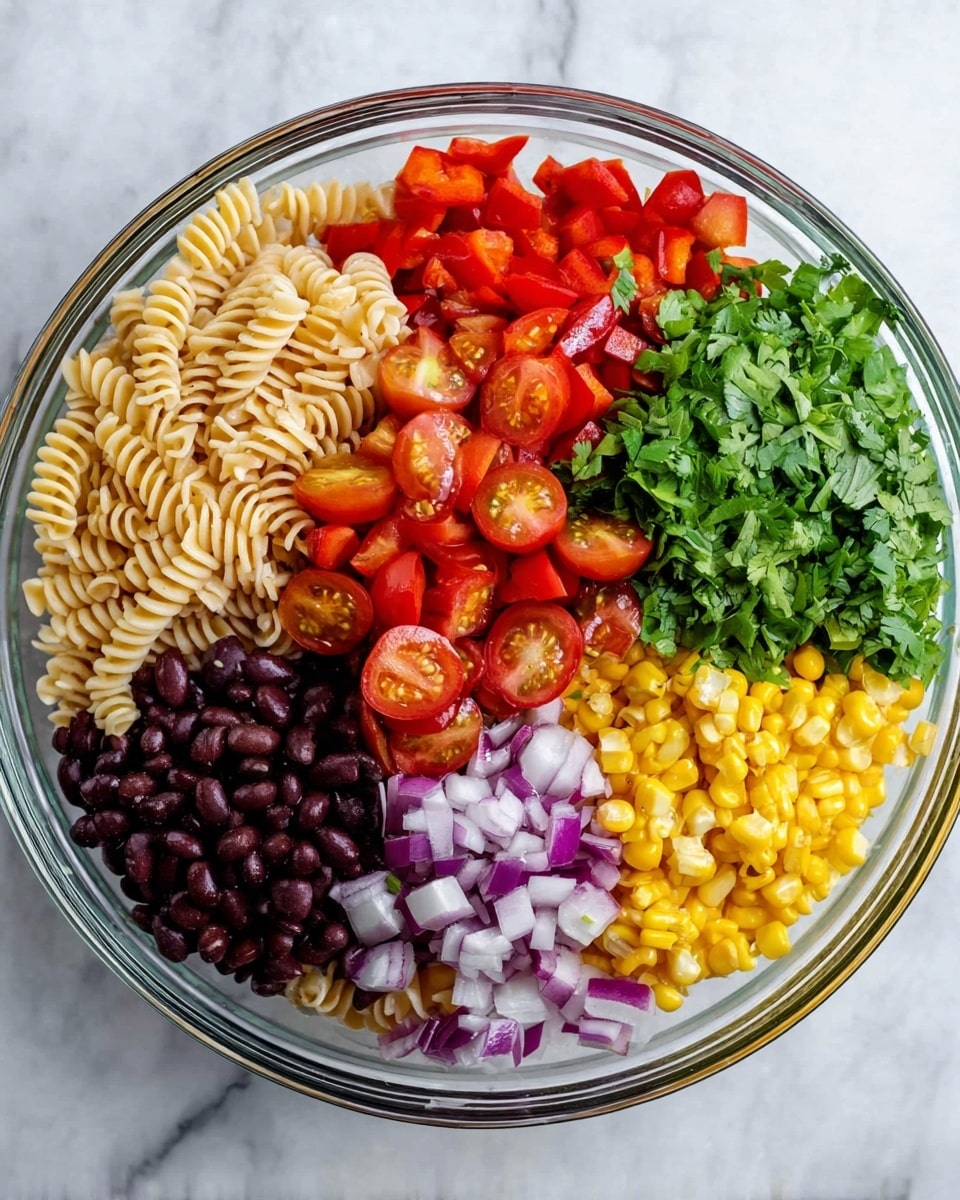 A clear glass bowl on a white marbled surface holds seven distinct layers of ingredients arranged side by side. Starting from the left, there are light beige spiral pasta, bright red diced bell peppers, and a pile of shiny dark black beans. Below them, there are halved red cherry tomatoes with visible seeds, followed by chopped purple onions in the center. To the right, there is a bright yellow layer of grilled corn kernels and a bunch of fresh green chopped cilantro leaves. Each layer is clearly separated, showing fresh and colorful textures. Photo taken with an iphone --ar 4:5 --v 7