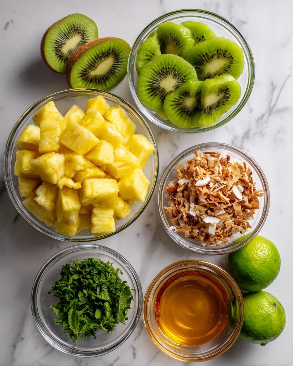 The image shows six clear glass bowls and two whole green limes on a white marbled surface. The largest bowl on the bottom left is filled with bright yellow pineapple cubes, showing a rough texture. To its upper right, there is a medium bowl filled with halved green kiwis, showing the smooth green flesh with black seeds. Next to the kiwi bowl, on the top right, is a small bowl holding light brown toasted coconut flakes mixed with white shredded coconut. Below this, a small bowl contains chopped green mint leaves with visible veins. In the center bottom part of the image is another small bowl filled with golden honey, showing a smooth, shiny surface. To the right of the honey bowl are two whole green limes with a slightly textured surface. The setup is neat and organized, with all items clearly visible on the white marbled background. photo taken with an iphone --ar 4:5 --v 7