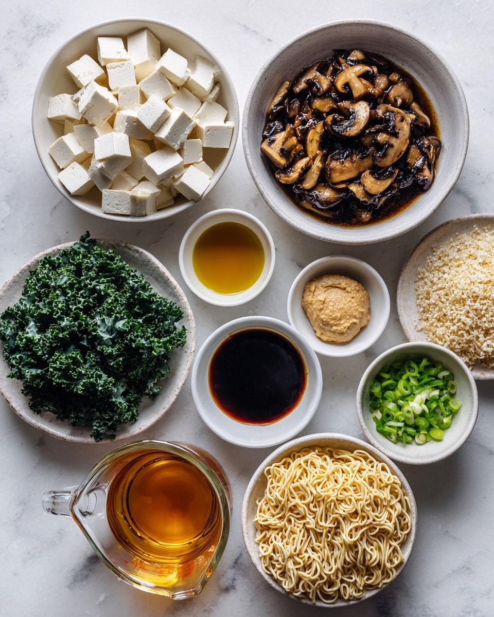 The image shows several white bowls and a clear measuring cup arranged on a white marbled surface, each containing different ingredients. Starting from the top left, there is a bowl filled with white tofu cubes. Below it, a larger bowl holds cooked mushrooms in a dark marinade with a rich brown color. To the right of the tofu, a small bowl contains a dollop of light beige miso paste. Below that, two small bowls hold golden sesame oil and dark tamari sauce. Another small bowl of dark tamari sits to the left of the mushrooms. A small cup with amber maple syrup is placed near the bottom left, next to a bowl of fresh dark green kale leaves beside a small dish of light minced garlic. To the right, a small bowl of chopped bright green onions is near the bottom right, beside two blocks of uncooked pale yellow ramen noodles in a white bowl. In the middle, a clear measuring cup holds golden veggie broth. Photo taken with an iphone --ar 4:5 --v 7