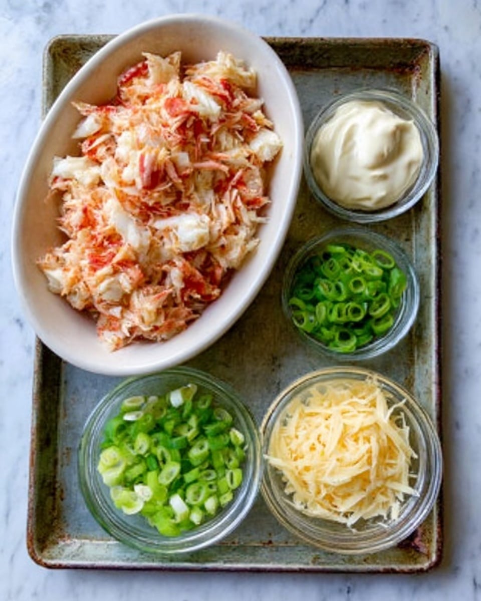 A white oval dish filled with chopped crab meat mixed with light red sauce sits on the left side of an old metal tray. To the right, there are three small clear glass bowls placed in a row: the top bowl holds creamy white mayonnaise, the middle bowl contains bright green sliced scallions, and the bottom bowl is filled with a small pile of shredded pale yellow cheese. The tray is on a white marbled surface. Photo taken with an iphone --ar 4:5 --v 7
