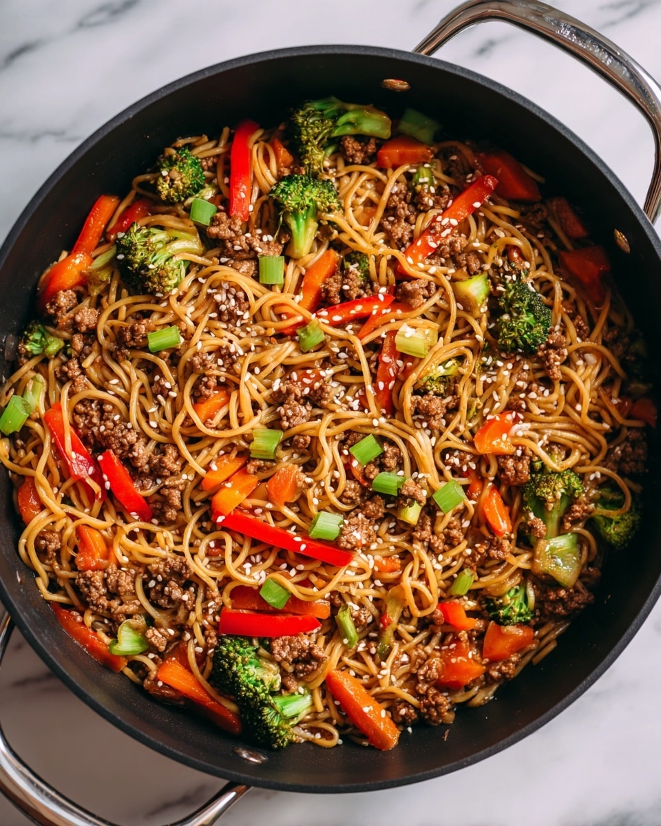 The image shows a black pot filled with a colorful stir-fry noodle dish. The bottom layer is light brown noodles soaked in a dark soy-like sauce. On top of the noodles are small pieces of cooked ground meat in brown shades. Mixed throughout are bright orange carrot sticks, several small green broccoli florets, and red bell pepper slices. There are also small pieces of green onion and white sesame seeds sprinkled over the dish. The sauce gives a shiny, slightly wet look to the noodles and vegetables. The whole pot sits on a white marbled surface. Photo taken with an iphone --ar 4:5 --v 7